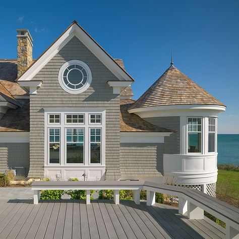 Seaside Refresher The renovation of this waterfront home demonstrates the marked impact of modest alterations. This 1980’s shingle home was lacking the drama of its oceanside setting and historic character of New England shingle style homes. A series of gable additions dramatically improve the interior and exterior of Vineyard Architecture, New England Style Home, New England Style Homes, Beach Cottage Design, New England House, New England Cottage, New England Beach House, England Beaches, Shingle Style Homes