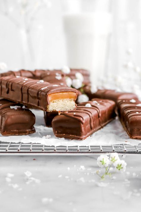 A soft and buttery cookie topped with a homemade chewy salted caramel, finished with a semi-sweet chocolate coating. Every bite of one of these Homemade Twix Bars is perfect sweet, chewy, and just SO. GOOD.