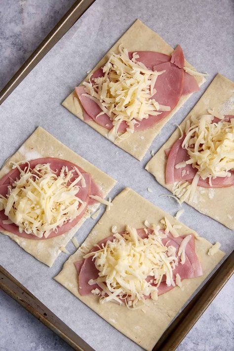 These ham and cheese puff pastries have a flaky puff pastry crust and gooey cheese interior sprinkled with a savory seasoning mix. The best part? You can eat them with your hands. No forks needed. Buttery pastry, salty ham, and melty cheese with a side of Dijon mustard? Talk about heavenly. Ham And Cheese Squares, Ham And Cheese Pastries, Puffed Pastry Sandwiches, Ham And Cheese Danish, Puff Pastry Ham And Cheese Pockets, Ham And Cheese Puff Pastry Appetizers, Puff Pastry With Ham And Cheese, Ham And Swiss Puff Pastry, Ham And Gruyere Puff Pastry