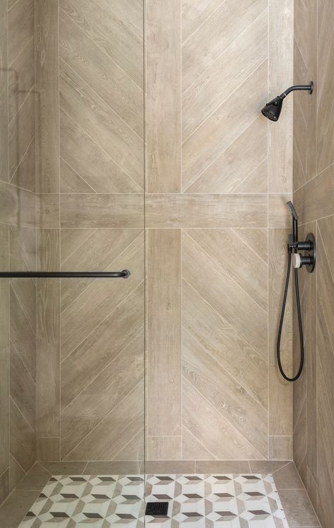 Lean into earthy elegance Bathroom Architectural Digest, Herringbone Shower Wall, Architectural Digest Bathroom, Accent Tile Bathroom, Master Shower Tile, Shower Accent Tile, Houston Interior Designers, Bathroom Shower Walls, Marble Showers