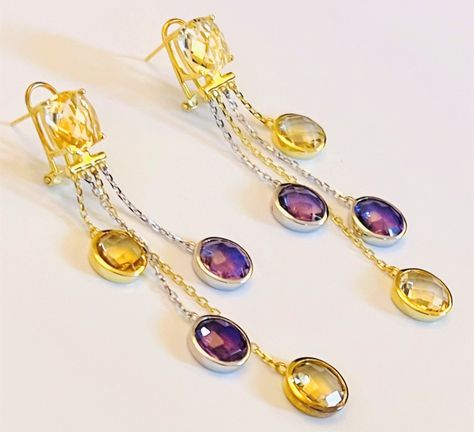 An elegant multi gemstones of Amethyst and Citrine long drop dangle earrings (65 mm , 2.56 inches drop) in 92.5 sterling silver (UK hallmarked). A beautiful two-tones of white silver and 18 carats yellow gold-plated earrings. The earrings has a total of 10 gemstones. Each earring has a cushion-cut yellow Citrine at the top, an alternate 2 round-cut yellow Citrine (in bezel setting) with 18 carats yellow gold-plated chain, and 2 round-cut purple Amethyst stones (in bezel setting) with white silve Ametrine Jewelry, Gemstones Pendant, Amethyst And Citrine, Blue Sapphire Pendant, Citrine Jewelry, Amethyst Stones, Beaded Jewels, Citrine Earrings, Purple And Yellow