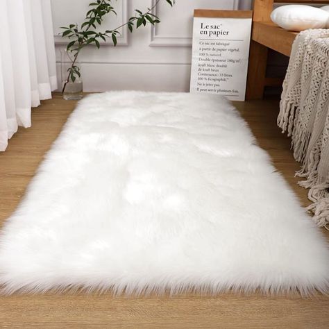 PRICES MAY VARY. ⭐3x5 White Fluffy Rug: The soft and fluffy white faux fur rug has a pile of about 2.6 inches. The high pile and high density gives the shag rug a fluffy look and gives you a soft and plush feel. ⭐Suede Backing & Reinforcing Seam Edge: This white fur rug is designed with a non-slip suede and hard-wearing bottom that is ideal for use on wood or other floor surfaces. The edges of the area rug are sewn in order to make the pile at the edges more solid, improving the durability and l White Faux Fur Rug, Fuzzy Rug, Shag Carpet, Faux Fur Rug, Fur Rug, Rug For Bedroom, Fluffy Rug, Room Kids, White Faux Fur