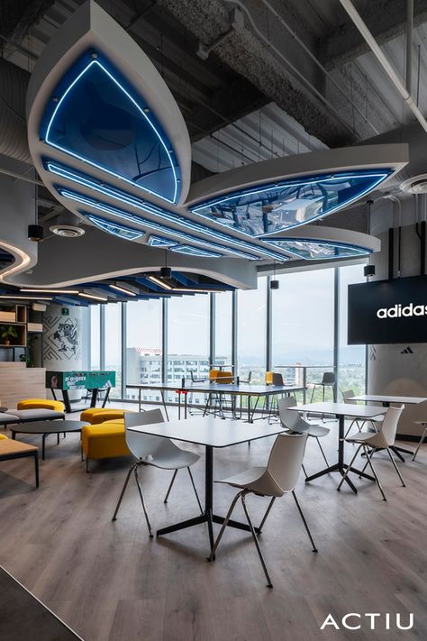 Modern office design inspiration is based on respect for the brand philosophy, ergonomics, dynamism and sustainability. In the new Adidas office interior design, in which ACTIU has taken part, these principles are respected through office workstations that facilitate communication, cafeteria areas, soft seating and ""phone-boxes"". Full story in the link!  #actiu #adidasoffices #modernofficedesigninspiration #officeworkstations #officelayout #officeinteriordesign Workstation Area Design Office, Apple Office Interior, Workstations Office Design, Tech Office Design, Ceiling Elements, Adidas Office, Office Cafeteria Design, Modern Corporate Office Design, Modern Office Design Inspiration