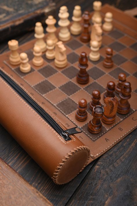 Leather Chess  Do you like to play chess and want to be able to do it even when you are on the go? A stylish leather roll for chess will give you such an opportunity. The set can be used at home, and at the same time it is compact enough to take with you on the road.    Advantages: * High-quality materials ensure a long service life. * Compact and lightweight, it is easy to store and light to transport. * Stylish design and excellent quality.    Product details: - 100% Handmade - Materials: genu Leather Chess Set, Leather Chess Board, Cool Chess Boards, Leather Ideas Handmade, Leather Products Ideas, Themed Chess Sets, Chess Design, Handmade Chess Set, Craft Market Display