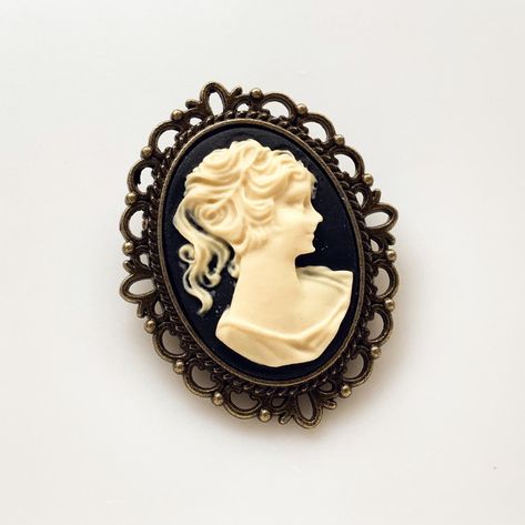 Cameo Brooch Vintage Lady Pin Brooch Bouquet Victorian Costume Cameo Jewelry -I make this brooch using a black and cream cameo and set it in an antique brass setting -Nickel free lead free alloy metal, resin cameo, C clasp closure -Measures 1 1/4" x 1 1/2" -Gift Boxed More of my Cameo Jewelry: https://www.etsy.com/shop/lydiasvintage?search_query=cameo More of my Brooches: https://www.etsy.com/shop/lydiasvintage?ref=seller-platform-mcnav§ion_id=6786664 Cameo Tattoo, Camphor Glass Jewelry, Victorian Costume, Gothic Victorian, Cameo Jewelry, Vintage Lady, Brooch Bouquet, Victorian Lady, Vintage Cameo