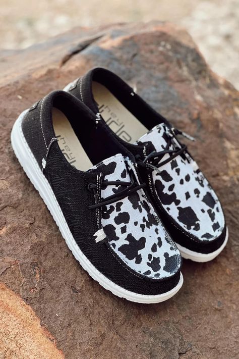 Black Western Shoes, Cow Print Hey Dude Shoes, Western Shoes Sneakers, Hey Dudes Cow Print, Hay Dude Shoes, Black Hey Dudes Outfit Women, Cow Hey Dudes, Cute Outfits With Hey Dude Shoes, Cow Print Hey Dudes