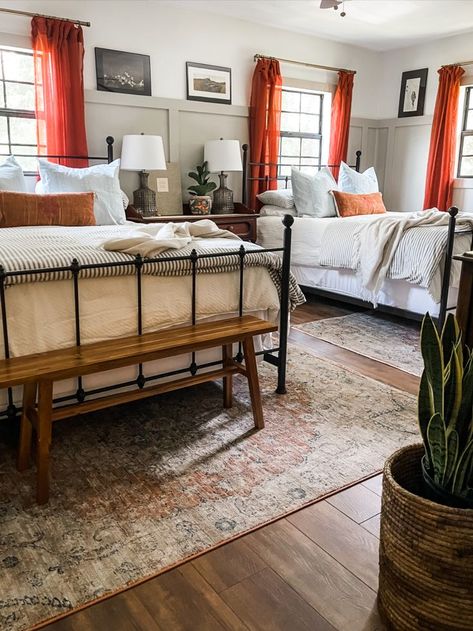 vintage modern guest room with two queen beds, four poster beds, #FoundItOnAmazon, board and batten, bench at the foot of the bed, cactus silk pillows, taupe walls, fawn pillows, lake house, vintage art, art ledge, board and batten with art ledge, bright curtains, burnt orange, LVP floors Two Queen Beds One Room, 2 Queen Beds In Room, Room With 2 Full Size Beds, Queen And Single Bed In One Room, Guest Room 2 Queen Beds, Guest Room 2 Beds, Double Queen Bedroom Guest Rooms, Guest Room With 2 Queen Beds, 2 Bed Guest Room