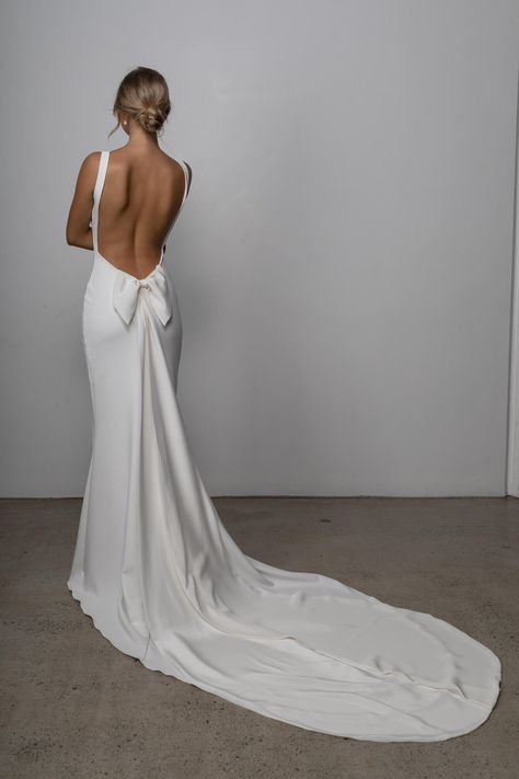 (4) - Scooped neckline, ultra low back, our dreamy stretch crepe fabric and a removable bow for a touch of romance- our Martini gown has it all! Could she be ‘the one’? Low Back Wedding Dress, Wedding Dress Low Back, Backless Bridal Gowns, Crepe Wedding Dress, After The Wedding, Lace Bride, Minimalist Wedding Dresses, Back Wedding Dress, Dress Guide