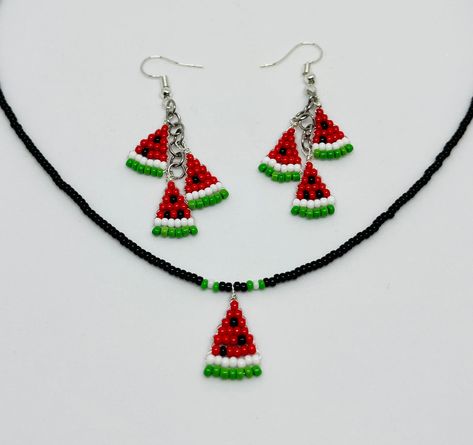 "This set is handmade with seed beads. The beaded watermelon slice hangs from a black seed bead necklace with accents of green and white. It has a silver lobster claw clasp. The beaded watermelon earrings contain three slices apiece.  Necklace measures approx. 17.5\" long. Watermelon slice is approx. 1.75\" long.  Earrings measure approx. 2.5\" in total length." Beaded Watermelon, Diy Earrings Dangle, Watermelon Earrings, Watermelon Necklace, Seed Bead Crafts, Wire Wrapped Jewelry Diy, Watermelon Slice, Cat Bead, Seed Bead Patterns