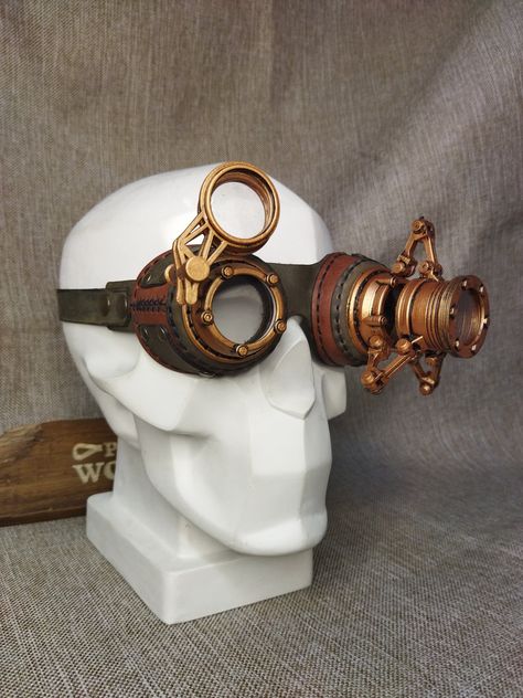 Leather steampunk goggles "Watchmaker" with clear lenses are complemented by an additional watchmaker's magnifying loupe and additional lenses. These glasses are the perfect addition to any steampunk or dieselpunk look! The glasses are made of genuine leather with 3D printed parts. *Glasses use clear lenses. Available with clear or dark lenses. (We do not use optical lenses in glasses. The lenses are made of acrylic glass.) Leather design by DiselPunk.Ro Skin color may vary slightly from image. Dieselpunk Outfit, Goggles Drawing, Rave Glasses, Aviator Goggles, Mode Steampunk, Steampunk Leather, Steampunk Goggles, Steampunk Accessories, Steampunk Design