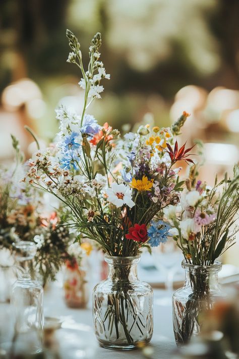 70+ Wildflower Centerpieces to Complete Your Boho Look | Matched Hearts Wild Flower Round Table, Wildflower Bridal Shower Table Decor, Wild Flower Centerpieces Wedding Simple, Soft Wildflower Wedding, Wedding Decorations Wildflowers, Simple Wildflower Centerpieces, Wild Flowers Centerpieces, Wildflower Bud Vases Wedding, Dark Wildflower Bouquet