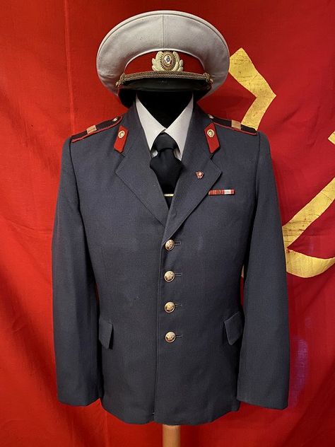 Daily dress uniform of a senior sergeant of the Soviet militia, the police force, mid to late 1970s as introduced in 1969 when the dark blue uniforms of the 1958 regulations were replaced. The tunic, in line with the 1969 regulations, is a gray militia officers gabardine uniform with matching red piped gray breeches and in this case a 1980s white summer visor cap. The white caps were part of the summer uniform and to be worn with the shirt, exceptions did occur yet the cap, to be correct, is to Officer Uniform, Daily Uniform, Summer Visor, Summer Uniform, Visor Cap, White Caps, Police Force, Daily Dress, White Summer