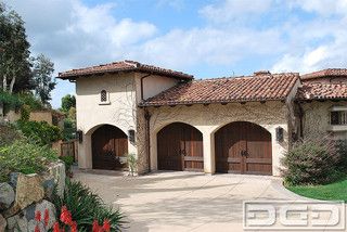 Old World Garage Doors, Pretty Garage, Tuscan Exterior, Nice Garage, Garage Door Decorative Hardware, Custom Wood Garage Doors, Mountain Style Homes, Custom Garage Doors, Tuscan Farmhouse