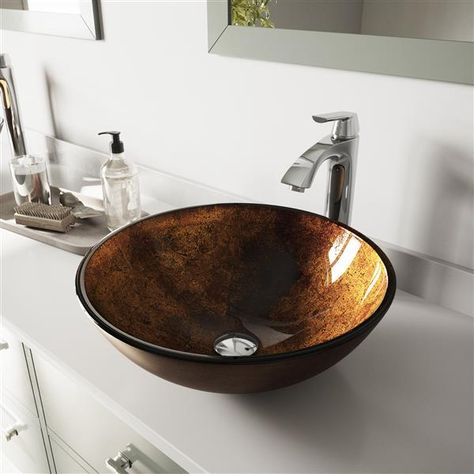 This elegant bathroom sink by Vigo® makes a stunning statement piece in any bathroom upgrade. The sink features a tempered glass and comes complete with a nickel faucet, matching pop-up drain and mounting ring.Single hole faucet install and countertop mount sink create a modern look in any homeSet includes all mounting hardware for sink and faucetSink features solid tempered glass construction with textured exterior and polished interiorVIGO Glass Vessel Sinks are handmade, and each may feature Bronze Sink Bathroom, Oil Rubbed Bronze Faucet, Glass Basin, Round Sink, Black Faucet, Glass Vessel Sinks, Vessel Faucets, Vessel Bathroom Sink, Vessel Sink Bathroom