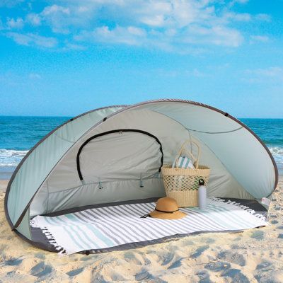 Make your outdoor adventure a memorable one by bringing along the Beach Tent Pop Up Shade by Wakeman. This beach cabana tent boasts a UV protection rating of UPF 50+, offers a mesh window for optimal ventilation, and features water repellent material. With instant set up that takes just seconds, this pop-up beach tent eliminates the hassle of set up and keeps your time spent experiencing the outdoors. More than just a beach pop-up tent, the lightweight portable tent is ideal to provide shade and Beach Tent Ideas, Popup Tent, Cabana Tent, Sports Tent, Beach Tents, Sun Tent, Pop Up Beach Tent, Cabin Retreat, Pool Backyard