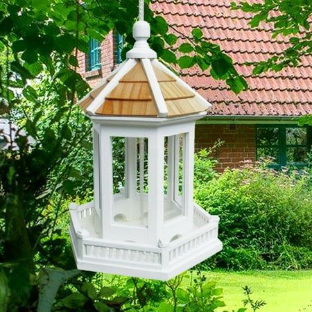 Classic Gazebo Bird Feeder This classic style Gazebo Bird Feeder is topped with a pine shingled roof and a railing all around. The top cone lifts up along the heavy-duty nylon cord (9.75 long) to access the large cavity capable of holding over 1.5 pounds of seed. The seed tray has drainage holes to allow water to escape. The top of the feeder lifts up to fill with seed and is 3.5 wide in diameter. This piece can be cleaned by lifting up the top and rinsing 1x-2x a year with a mild soapy water. F Gazebo Bird Feeder, Shingled Roof, White Gazebo, Christmas Tabletop, Tabletop Christmas Tree, Christmas Tree Garland, Tree Garland, Christmas Pillows, Roof Shingles