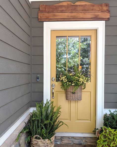 Colored Accent Door, Dark Green House Yellow Door, Leap Of Faith Benjamin Moore Front Door, Yellow Front Door Cottage, Muted Yellow Front Door, Benjamin Moore Leap Of Faith, Brown House With Colored Front Door, Outdoor Door Color Ideas, Green House Front Door Color