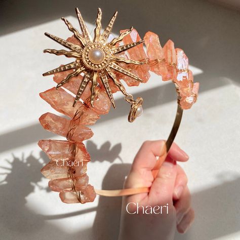 Meriel is a peachy-toned crystal crown with a sun charm decorated with a pearl.  ★ Follow us on instagram @Chaeri_Crystal_Crowns for updates, giveaways and sales!  LEAD TIMES: * Usually, crowns and crystal products are dispatched within 2-4 business days.  SHIPPING: * Please note that the international delivery times are an estimate and delays due to customs are out of my control.  * Australia 13 - 20 Business Days * USA & Canada: 13 - 20 Business Days  * UK: 10 - 14 Business Days  * Rest of Wor Coral Crown, Sun Wedding, Crystal Products, Festival Crown, Quartz Crown, Crystal Crowns, Sun Charm, Orange Crystals, Golden Sun