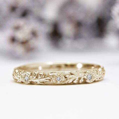 Inspired by nature, this one-of-a-kind ring features three Poppy flowers in an intricate leaf pattern in a gold band. The leaf pattern goes to the halfway point, and is hand engraved with special care and attention, meaning that your nature wedding ring will truly be one of a kind. Within each flower is set a sparkling small diamond. Each of our pieces is tailor-made and handcrafted with love and care in our workshop, just for you. Please allow up to 3 weeks for us to make it.All pieces come lov