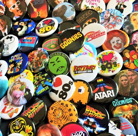 You will receive a set of (six) 80s Mystery Pinback Buttons. See any you have your eye on? Just add them to notes below. Want to make a custom set of your own? Just send us a message of your buttons and we will design and send your own listing! ⭐️ ⭐️Buttons are 1.25 inches in size or size of a quarter. Stop by our shop https://www.etsy.com/shop/MagicUniqueTreasures for more magical treasures! 80s Pins And Patches, Etsy Shop Aesthetic, Things I Want To Buy List, Pin Ideas Button, Button Pins Aesthetic, Mystery Scoop, 80s Shows, Style Année 80, Buttons Design