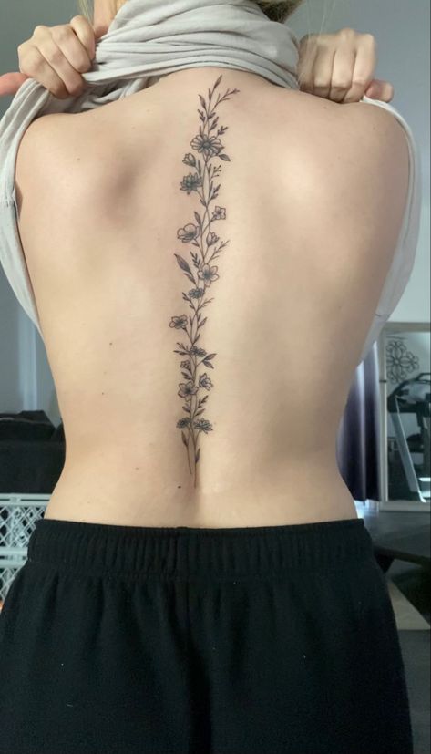 Asthetic Tattoos Spine, Back Tattoos Delicate, Vine On Spine Tattoo, Curvy Spine Tattoo, Cosmos Spine Tattoo, Floral Tattoo Design Spine, March Flower Spine Tattoo, Spine Tattoos On Women, Southern Spine Tattoos