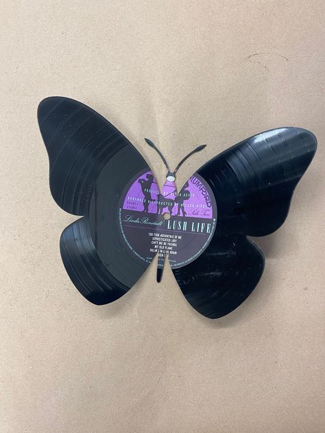 "the butterfly is laser cut and bent to give it that one of a kind look. It is 9 1/2\" wide when bent and almost 7\" tall Made from used records, the album is chosen at random. Our vinyl art is cut by with our laser, we can get pretty creative and detailed with the designs. All of our items are made local in the USA, by us Buffalo Customs. You guessed it right in Buffalo NY. We use a precision laser to cut or engrave our products. We do offer local pick up at our retail location, or we can ship Vinyl Projects Ideas Wall, Vinyl Record Butterflies, Cool Vinyl Designs, Crafts With Records Vinyls, Painted Vynal Records, Painted Vinyl Records Aesthetic, Vinyl Painting Ideas, Vinyl Collage, Creative Room Ideas