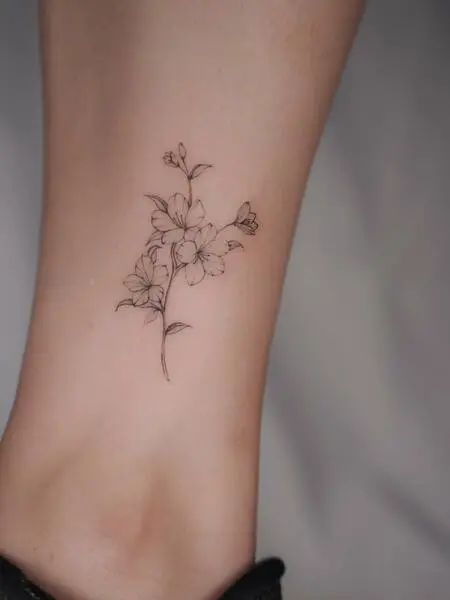 Simple Cherry Blossom Tattoo Cherry Blossom With Words Tattoo, Rib Tree Tattoos For Women, Hand Wrist Tattoo Placement, Cherry Blossom Tattoo Placement, Cherry Blossom Tiny Tattoo, Sakura Small Tattoo, Sakura Blossom Drawing, Cherry Bollsom Tattoo, Simple Sakura Tattoo