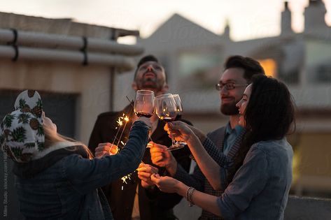 Friends celebrating together by Milles Studio for Stocksy United. Group of friends clinking glasses with red wine and holding sparkling lights having fun on rooftop. Friends Celebrating, Cristino Ronaldo, Glasses Of Wine, Friends Drinks, Sparkling Lights, Friends Gathering, Fit Couples, Group Of Friends, Street Photo