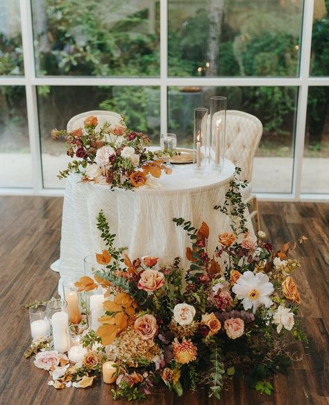 table for bride and groom orange fall florals wedding day decor Muted Fall Floral Arrangements, Outdoor Wedding Reception Flowers, Fall Garden Wedding Decor, Fall Boho Chic Wedding, Fall Wedding Table Cloths, Chic Fall Wedding Decor, Fall Wedding Mr And Mrs Table, Elegant Fall Wedding Flowers, Autumn Sweetheart Table