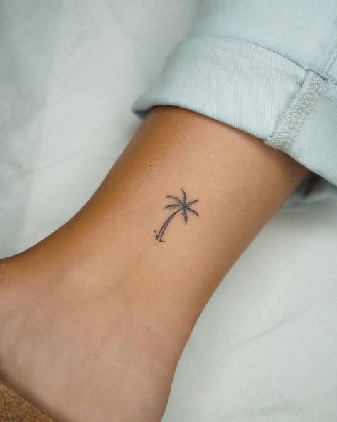 Little minimalistic palm tree tattoo located on the Tiny Tattoos Palm Tree, Palm Tattoo Minimalist, Small Holiday Tattoos For Women, Palm Tree On Ankle, Palm Tree Tattoos Small, Tattoo Ideas Female Palm Tree, Holiday Small Tattoos, Small Tattoo Palm Tree, Palm Tree Tattoo Line Work