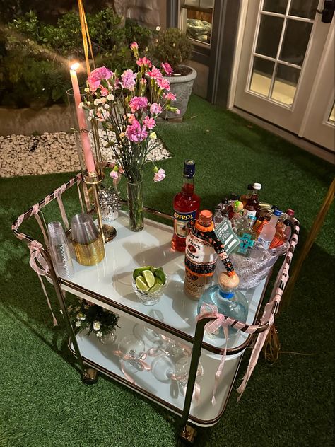 Decorated bar cart for 21st birthday dinner wirh pink ribbons and balloons 21st Birthday Bar Cart, Mini Bar For Party, 21st Birthday Ideas College, Decorated Bar Cart, Chill 21st Birthday Ideas, College 21st Birthday Party, 21st Birthday Ideas Decorations Outdoor, Fun 21st Birthday Ideas, 21st House Party