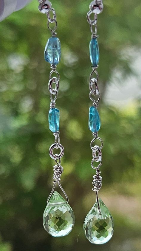 Elevate Your Style with Vibrant Elegance Introducing our Blue Apatite and Green Amethyst Dangle Earrings--a perfect blend of vibrant color and sophisticated design. Handcrafted with care, these earrings feature striking blue apatite and delicate green amethyst gemstones, elegantly set in sterling silver. Whether you're dressing up for a special occasion or adding a touch of elegance to your everyday look, these earrings are the ideal accessory. Key Features: Vibrant Blue Apatite: Known for its a Green Amethyst Earrings, Gemstone Properties, Aquamarine Crystal, Sterling Silver Drop Earrings, Blue Apatite, Amethyst Earrings, Unique Gemstones, Green Amethyst, Vibrant Blue