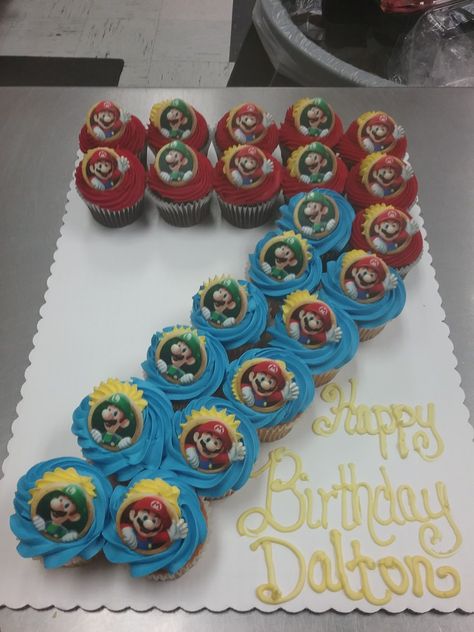 Cupcake cake number 7 with Mario rings #7 Cake, Super Mario Pull Apart Cupcake Cake, Mario Birthday Cupcake Cake, Number 7 Pull Apart Cupcakes, 7 Cupcake Cake Number, Number Cupcakes For Boys, Super Mario Number Cake, Mario Pull Apart Cupcakes, Number 7 Cupcakes