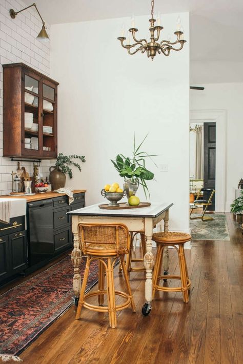 Shotgun House Interior, Counter Cabinets, Wicker Chandelier, Work Office Design, Shotgun House, Brass Sconces, Black Appliances, Island Chandelier, Central Kitchen