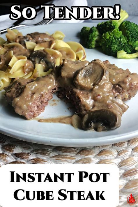 a piece of cubed steak cut open, covered in mushroom gravy with noodles and broccoli behind. Salsbury Steak Recipe Easy Instapot, Instant Pot Cube Steak Cream Of Mushroom, Instant Pot Cube Steak And Gravy, Instant Pot Cube Steaks, Instapot Cubed Steak And Mushroom Gravy, Pressure Cooker Cube Steak, Easy Cube Steak Recipes Instant Pot, Insta Pot Cubed Steak Recipes, Cube Steak Instapot Recipes