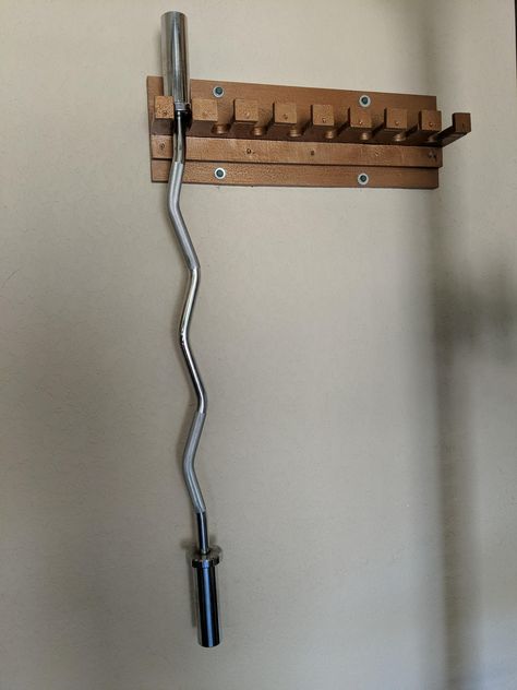 DIY 8 barbell holder. Made with some scrap plywood and painted with metallic oil paint. Nordic Hamstring Curl Diy, Diy Fitness Equipment, Diy Weights, Barbell Storage, Gym Rack, Home Made Gym, Home Gym Storage, Home Gym Basement, Gym Organizer