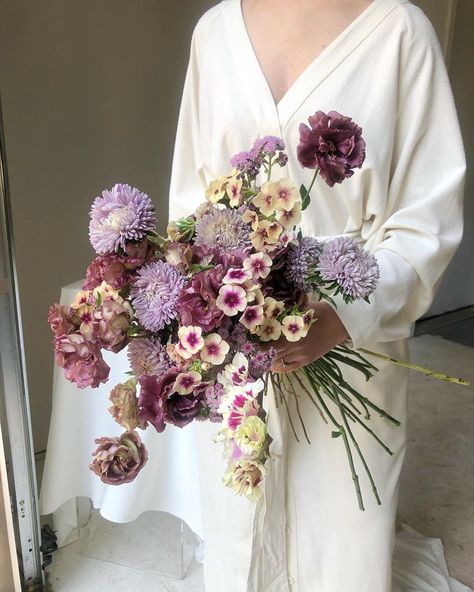 Ashley Fox Designs on Instagram: “More dusty violet requests please ☂️ image @heathertrachsel  wrap dress @shopidun  100% locally grown @tcflowerexchange  @humblepiefarmer” Asymmetrical Bouquet Wedding, Dusty Lavender Wedding, Lavender Bouquet Wedding, Vintage Purple Wedding, Purple Flowers Wedding, Whimsical Bouquet, Violet Bouquet, White And Purple Flowers, Lavender Bridal Bouquet