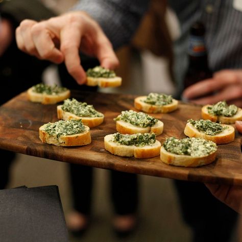 someone grabbing an appetizer off of a serving platter at a party. Roasted Whole Eggplant, Party Food Hacks, Room Temperature Appetizers, Cheese Ball Dip, Creamy Spinach Dip, Greek Appetizers, Easy To Make Appetizers, Wedding Appetizers, Make Ahead Appetizers