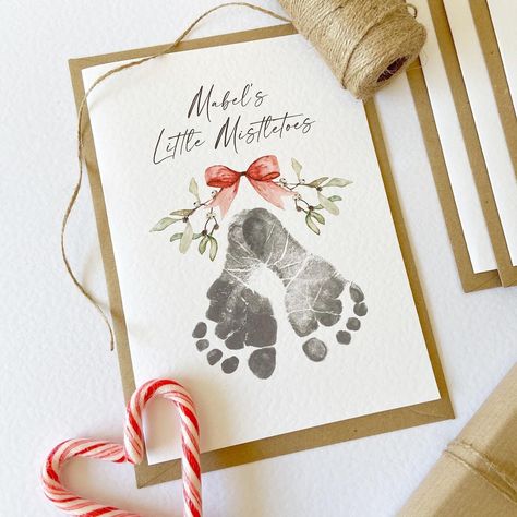 Send your loved ones some Little Mistletoes this Christmas with our Footprint Card Kit. Not only do they make a beautiful keepsake, but they make a fun activity for the family over the festive season.  Each kit contains:  - A5 Personalised Little Mistletoes Cards, printed on high quality white hammered card, in a quantity of your choice. Multiple names can be added e.g 'Name & Name's Little Mistletoes'.  - 1 x Test sheet with instructions, explaining fully how to capture your little one's footprints  - 1 x Baby safe ink pad which is safe to use from birth (if selecting the 'with ink pad' option) - C5 Kraft envelopes for each card  Keeping your baby's skin safe is our number one priority, which is why we have ensured our ink pads are 100% baby-friendly and conform fully to the strict standa Mistletoes Footprint, Mistletoes Footprint Craft, Mistletoe Footprint, Handprint Christmas Cards, Baby Footprints Christmas, Baby Christmas Crafts, Baby Holiday Photos, Baby Christmas Card, Baby Art Crafts