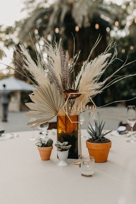 Minimalist tabletop wedding design with pampas grass, gold table number, and potted plants. Cactus Centerpieces, Wedding Cactus, Cactus Centerpiece, Modern Wedding Centerpieces, Boho Wedding Dress With Sleeves, Boho Wedding Centerpieces, Zoo Wedding, Succulent Centerpieces, Dried Florals