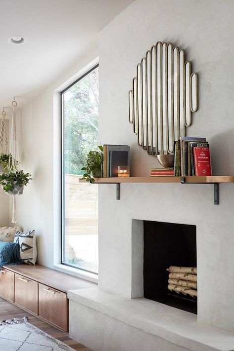 a stylish modern concrete fireplace with a mantel with books and a catchy mirror over it plus a bench next to it Fixer Upper Season 5, Jo Gaines, Stucco Fireplace, Gamble House, Fixer Upper House, Chip And Jo, Concrete Fireplace, Home Fireplace, Fireplace Makeover