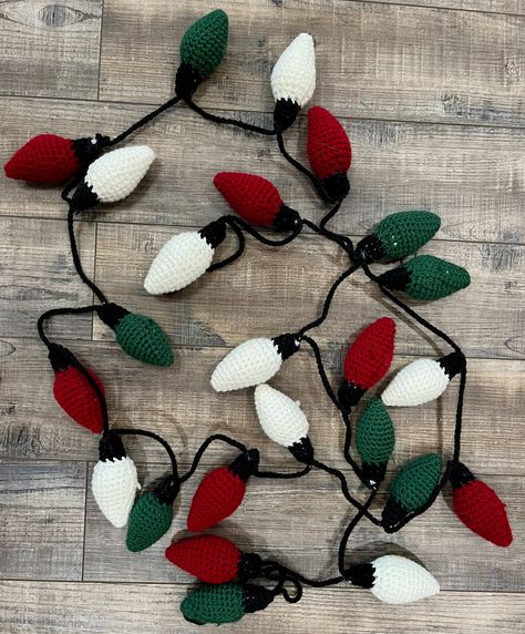 Looking for a hand crafted decoration to add to your collection this holiday season? Just looking for something fun to add to an entertainment system or shelf in your home or office? We have the product for you, crochet traditional colored Christmas light bulb garland! Our garland is hand crochet with premium yard in dark red, dark green, and white and black tops to tie it all together. We offer it in two different lengths 6 feet (72 inches) and 10 feet (120 inches). Please choose which length you would like at check out. Our 6 foot length will feature five of each color bulbs (dark red, dark green, white) and our 10 foot length will feature eight of each color bulbs.  Would you like the garland shorter or longer? Or in different colors? Check out our other color options by visiting our sh Crochet Christmas Lights, Knitted Bunting, Crocheted Christmas, Crochet Garland, Confection Au Crochet, Crochet Xmas, Holiday Garlands, Holiday Crochet, Christmas Crochet Patterns