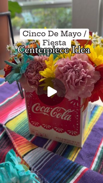 Need a quick & easy decor idea for a Fiesta Party pr Cinco De Mayo in May? Don't throw away your Mexican Cola carrier instead create a beautiful, colorful floral arrangement! #cincodemayo #fiestaparty #diydecor #diyparty #fiestaparty #tacoday #floral #centerpiece #intentionalparty #intentionalcelebration #partytheme #party #may5th #tacos Mexican Floral Arrangements, Fiesta Theme Centerpieces, Mexican Party Centerpiece, Mexican Centerpiece Ideas, Mexican Centerpiece, Taco Party Decorations, Colorful Floral Arrangement, Easy Decor, Taco Party