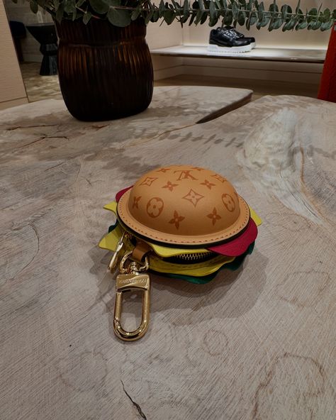 The LV Burger Bag Charm playfully reinterprets a classic House symbol, adding it to the diner sandwich—green lettuce, red tomato, yellow cheese, and Monogram bread included. With a silver-toned zip closure, the leather pouch hooks onto belt loops for instant joy and can hold a wireless earphones case. A unique gift, the multicolored LV Pizza Key Holder and Bag Charm is pure fun. The House heritage is translated into leather toppings: red pepperoni and green basil with Monogram Flowers, and ... House Symbol, Green Lettuce, Closet Decor, Red Tomato, Bag Aesthetic, Bags Aesthetic, Bag Charms, Earphone Case, Wireless Earphones