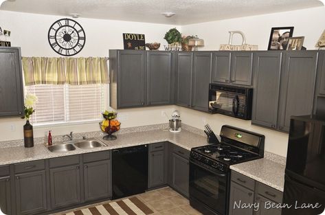 LOVE; they did gray paint in Olympic Nights Arbor, with black glaze on top - LOVE!  Plus, I like it with the blank appliances, which I haven't see (we have black appliances), & it looks good Cabinets With Black Appliances, Kitchen Cabinets With Black Appliances, Glazed Kitchen Cabinets, Kitchen Cabinets Before And After, Black Appliances, Cabinets Diy, Gray Paint, Black Glaze, Grey Kitchen Cabinets