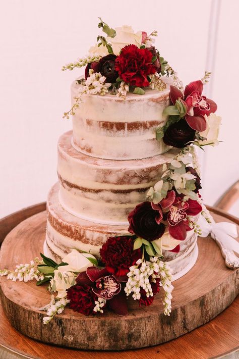 Semi naked wedding cake with trailing red carnations and burgundy orchids on a rustic wood round | Popcorn Photography Burgundy Wedding Flowers, Burgundy Wedding Cake, Blush Wedding Colors, Bush Wedding, Burgundy And Blush Wedding, Wedding Cake Rustic, Fall Wedding Cakes, Rustic Wedding Cake