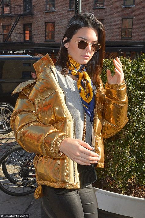 Glam: The model covered her eyes with gold-rimmed sunglasses and left her brunette tresses to hang loose in a centre parting Gold Puffer Jacket, Scarf Styling, Ports 1961, Shiny Jacket, Metallic Jacket, Gold Jacket, Jenner Sisters, Puffy Coat, Kendall Jenner Outfits