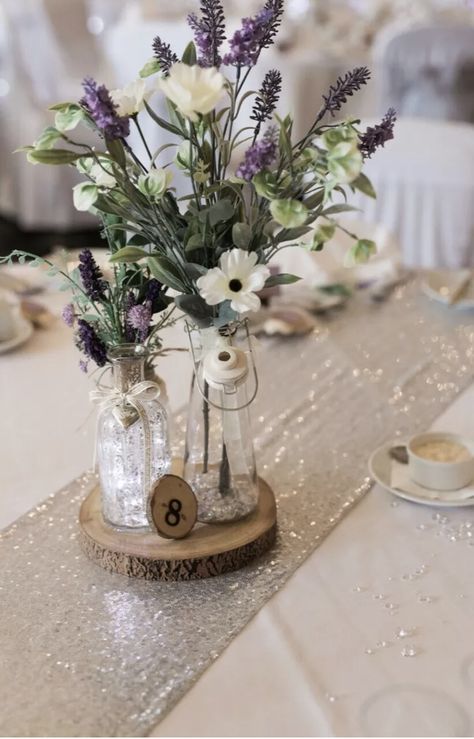 Lavender Plant Centerpiece Wedding, Lilac Wedding Centrepiece, Rustic Lilac Wedding Decor, Lavender And Baby Breath Centerpieces, Lavendar Table Setting Wedding, Lavender Theme Decoration, Lavender Table Centerpieces, Light Purple Flower Centerpieces, Simple Lavender Centerpieces