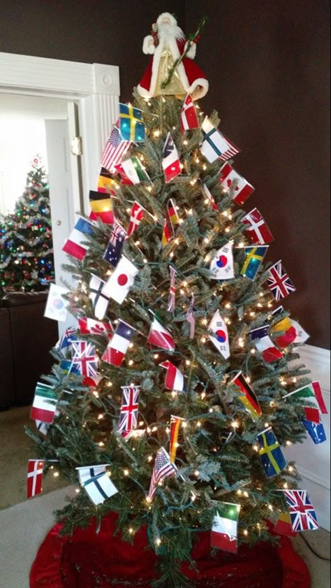 Flag Christmas Tree, Christmas Around The World Party Theme, Around The World Parade Float Ideas, Multicultural Holiday Decorations, Holidays Around The World Decorations, Christmas Trees Around The World, Christmas Around The World Parade Float Ideas, Christmas Around The World Float Ideas, Christmas Decorations Around The World