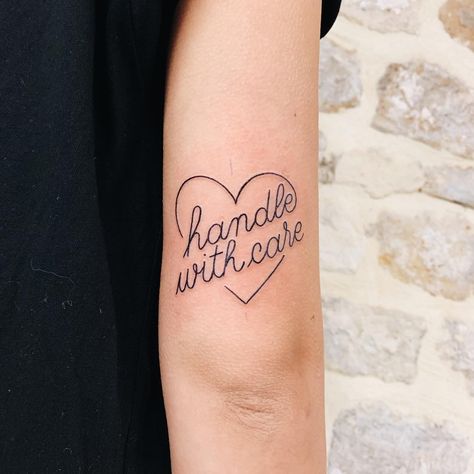 Words ‘handle with care’ inked on the right triceps. Was done at Bonjour Tattoo Club. Bonjour Tattoo, Handle With Care Tattoo, Linear Tattoo, Anti Flash, Artsy Tattoos, Club Tattoo, Health Tattoo, Self Love Tattoo, Octopus Tattoos